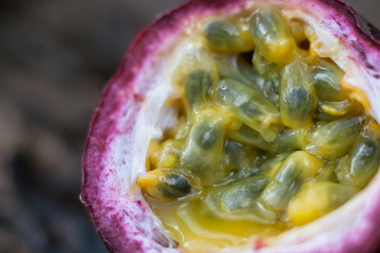 Macro shot of the cutted fresh passion fruit on rustic vintage w