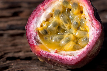 Macro shot of the cutted fresh passion fruit on rustic vintage w