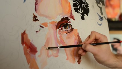 Process of painting male portrait on canvas