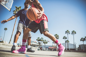 Two basketball players playing outdoor in LA