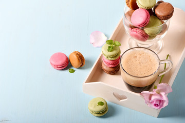 French sweets macaroons for dessert with coffee on a tray