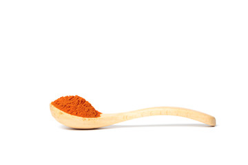 Chili powder in a wooden spoon isolated over white background
