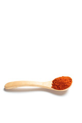 Chili powder in a wooden spoon isolated over white background