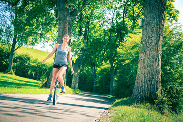 Young Woman Riding Her Unicycle © nullplus