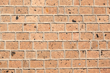 A brick wall built of bricks of the Armenian tuff