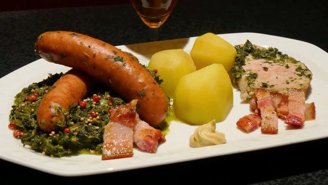 Kale with mette ends and kassler chops rotating close - green cabbage 4k 11858

