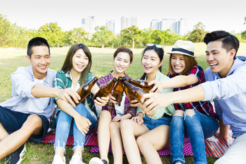 young Friends having fun together  and drinking  beer