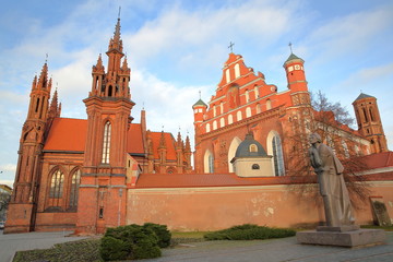 Fototapeta na wymiar VILNIUS, LITHUANIA: St Anne's Church and Bernardine Church with Adam Mickiewicz statue on the right hand side