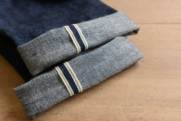 fold hem broken twill selvedge japan denim jeans on wooden background