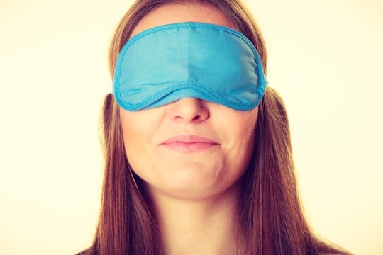 Brunette woman sleeping in blue eye sleep mask