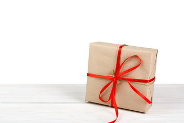 Christmas holiday gift box wrapped in paper isolated on white