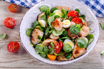 Chicken salad with vegetables and eggs.