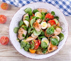 Chicken salad with fresh vegetables and eggs.