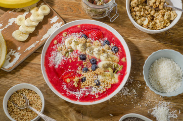 Breakfast berry smoothie bowl topped with banana, strawberry, bl