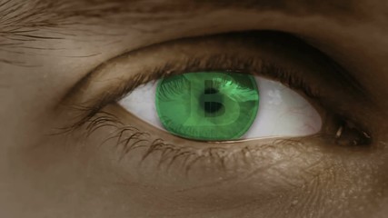 Close-up of eye with computer text overlayed. Zoom in centr. Bitcoin sign