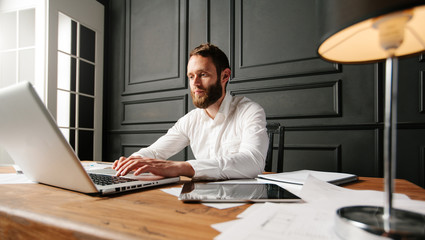 Businessman at a workspace typing