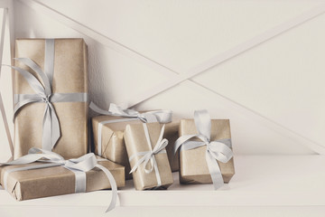 Elegant presents, gift boxes on white shelves background, closeup