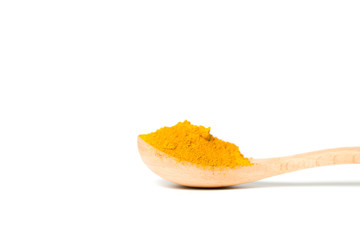 Turmeric powder in a wooden spoon isolated over white background