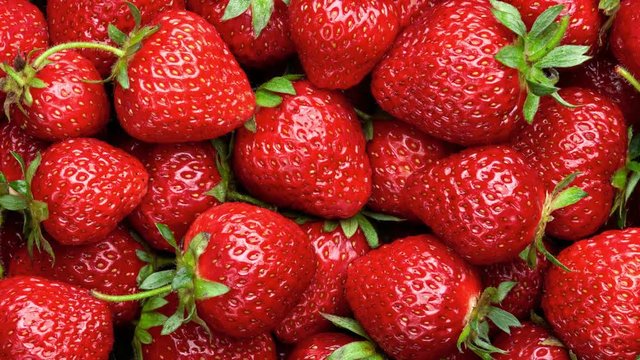 Strawberry background. Red ripe organic strawberries on market counter. UHD, 4K