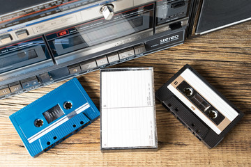 cassette tapes and recorder on old wooden surface