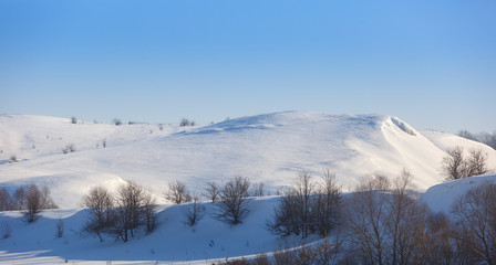 Fototapeta premium Panoramic view of snow-covered hills in central Russia. Winter s