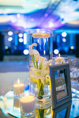 The frame and vases stand on the birthday table