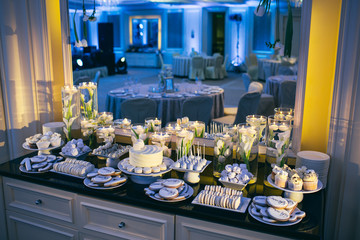 The buffet table with cake and biscuits