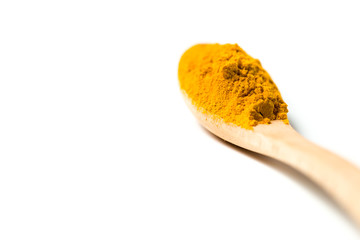 Turmeric powder in a wooden spoon isolated over white background