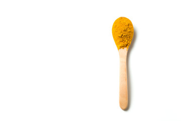 Turmeric powder in a wooden spoon isolated over white background