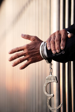 hand of businessman in jail as background with blur copyspace.