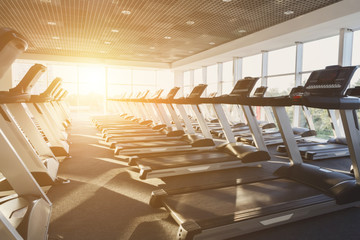 Modern gym interior with equipment, treadmills for fitness cardio training