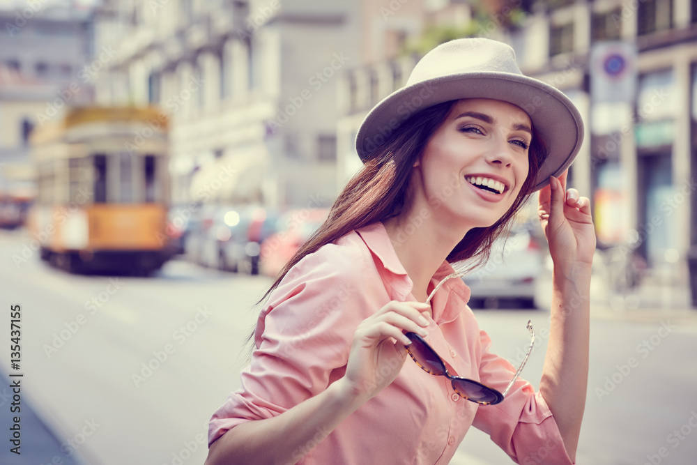 Wall mural Fashionably dressed woman on the streets of a small Italian town