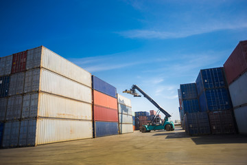 Fototapeta premium Forklift handling container box loading to truck in logistic zon