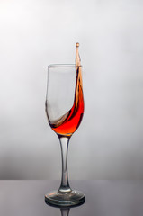 splash of red wine in a glass