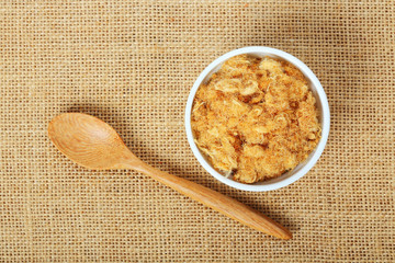 dried pork floss in white cup with wooden spoon on sack
