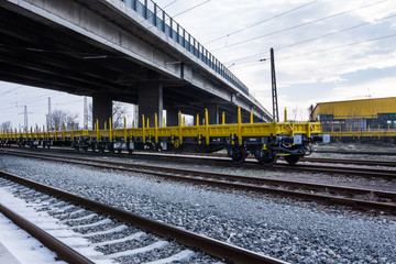 Burgas, Bulgaria - January 27, 2017 - Freight cargo train - yellow black New 4-axled flat cars wagons Type:Res Model:072-2- Transvagon AD