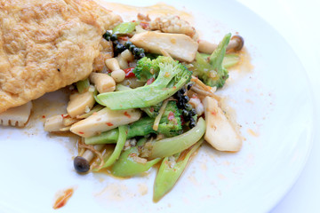 Stir fried Spicy Seafood with black pepper and thai style omelette with rice on white dish,  Thai spicy herb food / Image select focus