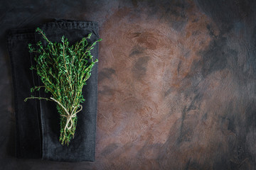 Thyme tied on a rusty background with copy space. Top view, flat lay - obrazy, fototapety, plakaty