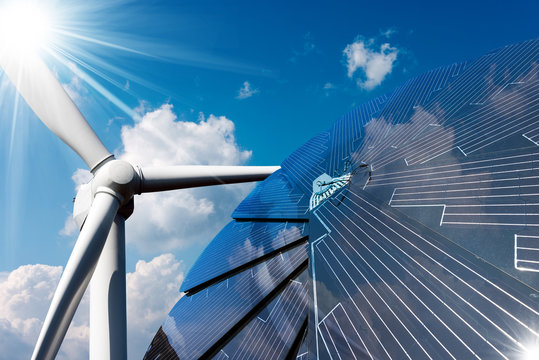 Solar panel and a wind turbine on a blue sky with clouds - Green energy concept