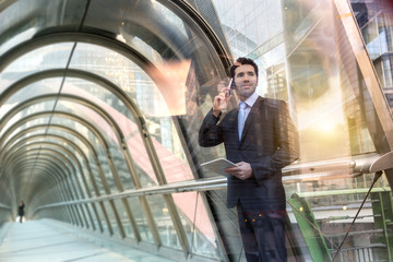 Businessman talking on the phone in financial district