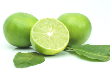 green lime with leaves isolated on white background