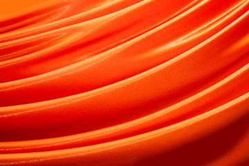 Beautiful folds of the curtains of satin material Orange