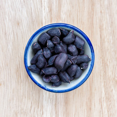  Raw Organic Pinto beans in bowl on wood floor background.