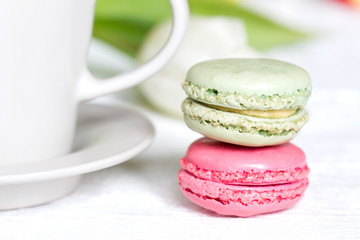 Cup of coffee with macaron on white background abstract still life
