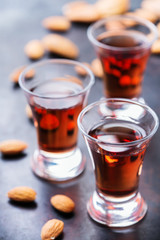Almond liquor amaretto on a grunge black table