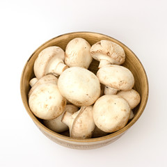 mushrooms in a bowl on a white background