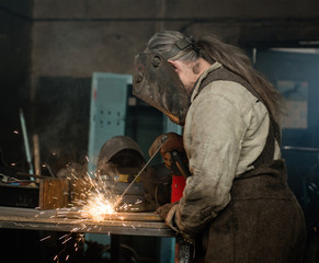 Industrial Worker at the factory welding