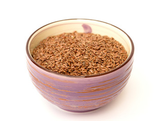 Flax seeds in a bowl on a white background