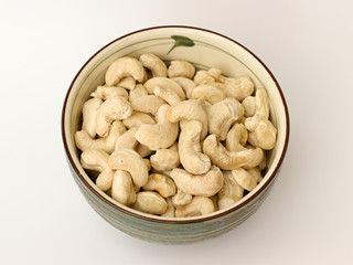 cashew nuts in a bowl on a white background
