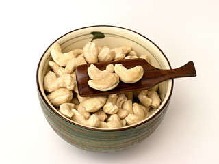cashew nuts in a bowl on a white background